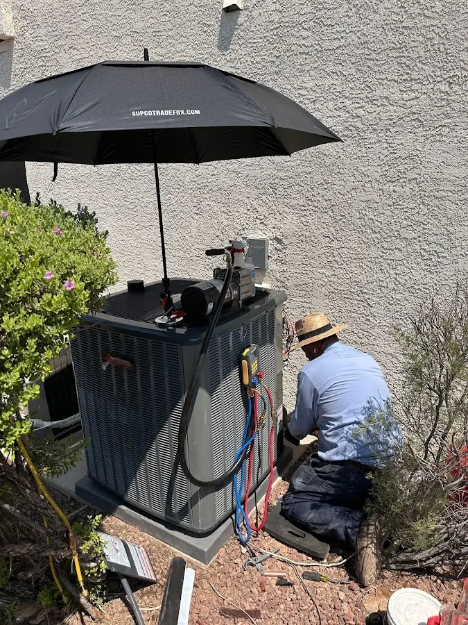 HVAC technician performing outdoor AC maintenance in Bradford